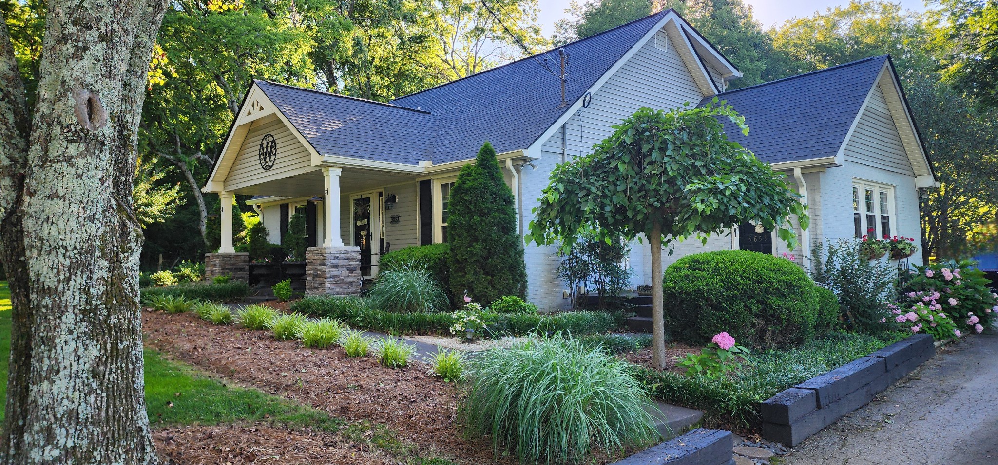 a view of a house with garden and trees