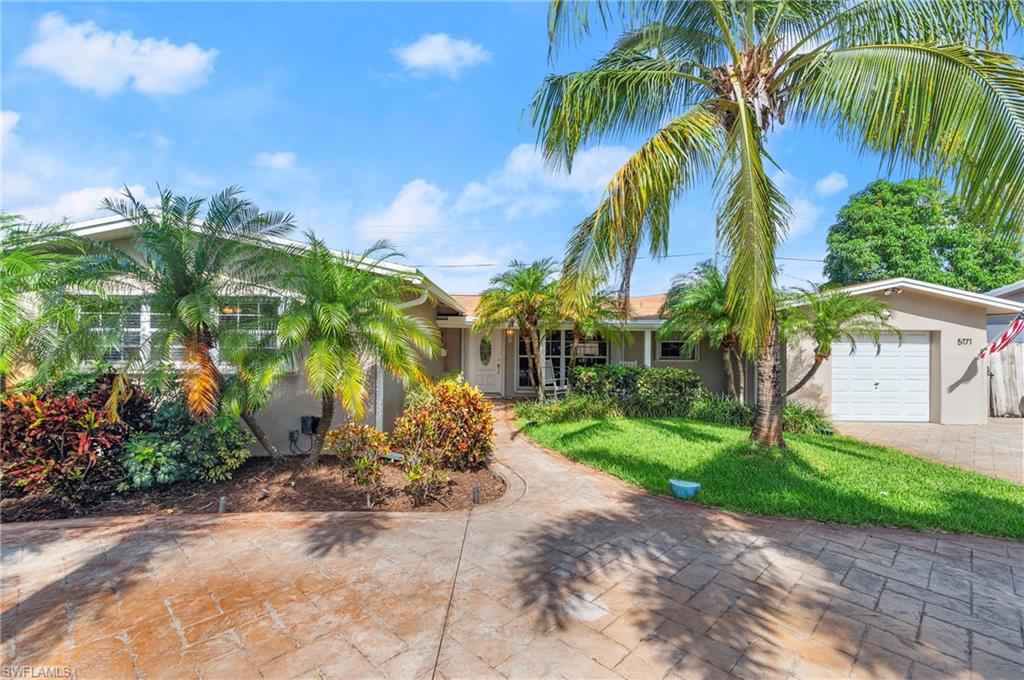 a view of a palm trees in front of a house