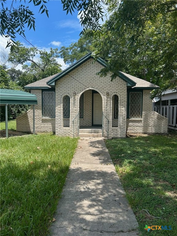 a front view of house with yard and green space