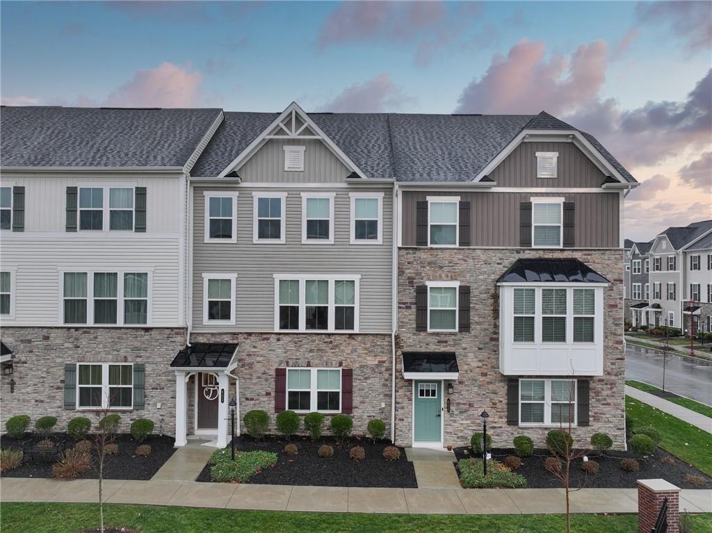 a front view of a residential apartment building with a yard