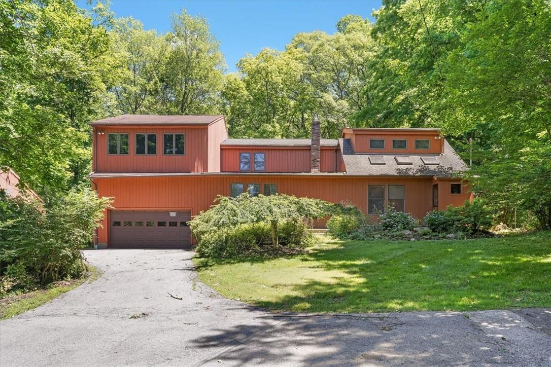 View of front of house featuring a garage and a front yard