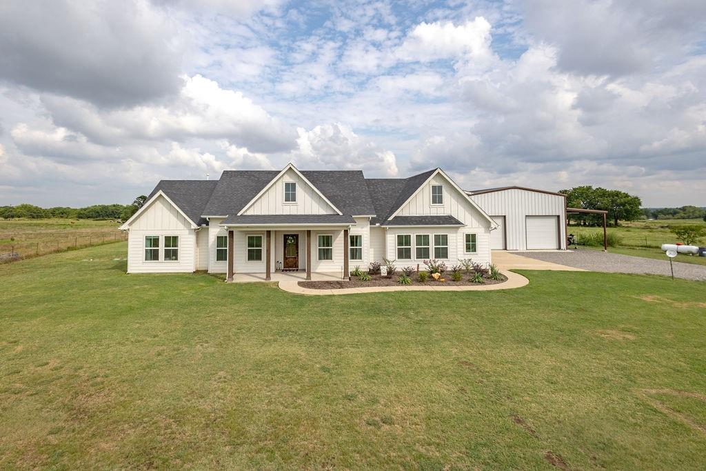 a front view of a house with garden and deck