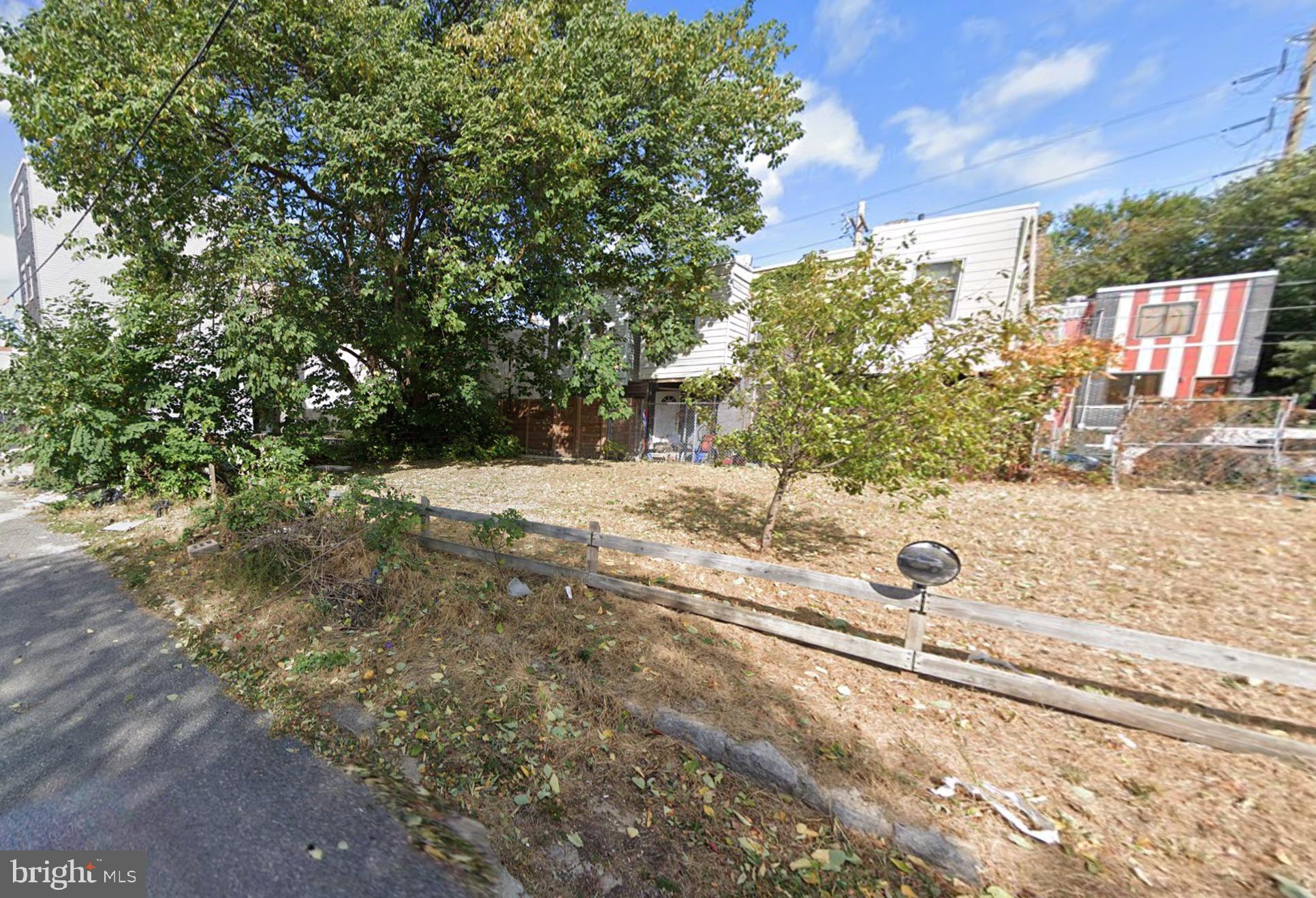 a view of a yard along with trees