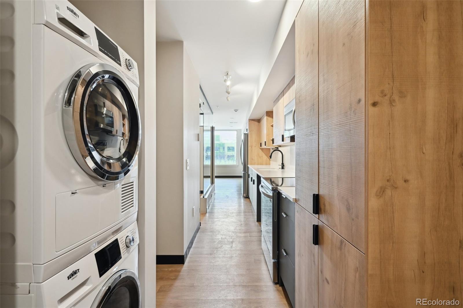 a view of a hallway with washer and dryer