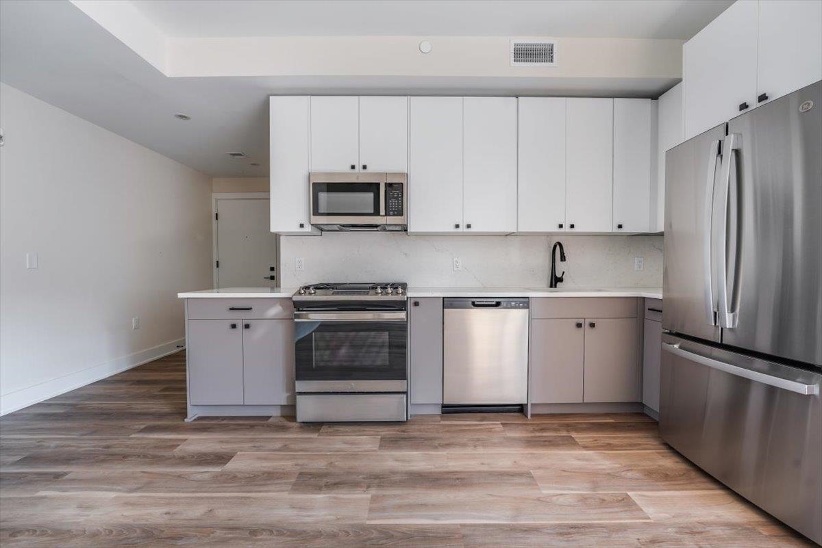 a kitchen with a sink a stove and refrigerator