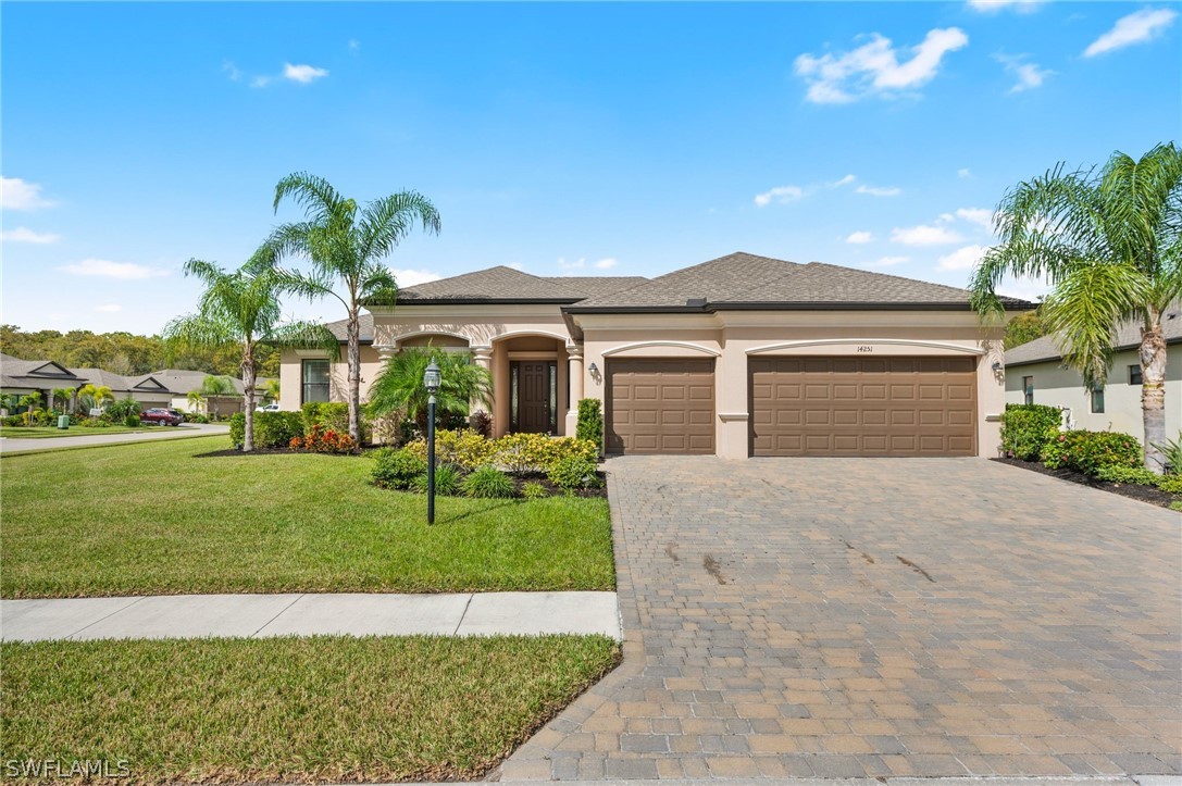 a front view of a house with a yard and garage