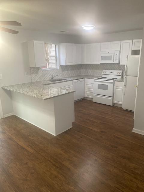 a kitchen with cabinets appliances a sink and a counter top space