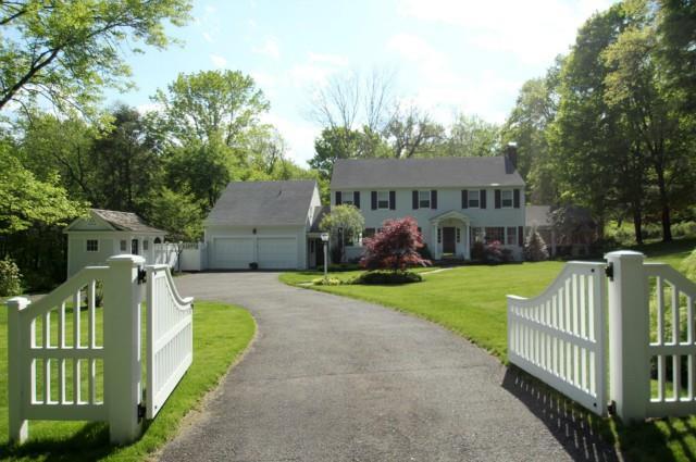 a front view of a house with garden and deck