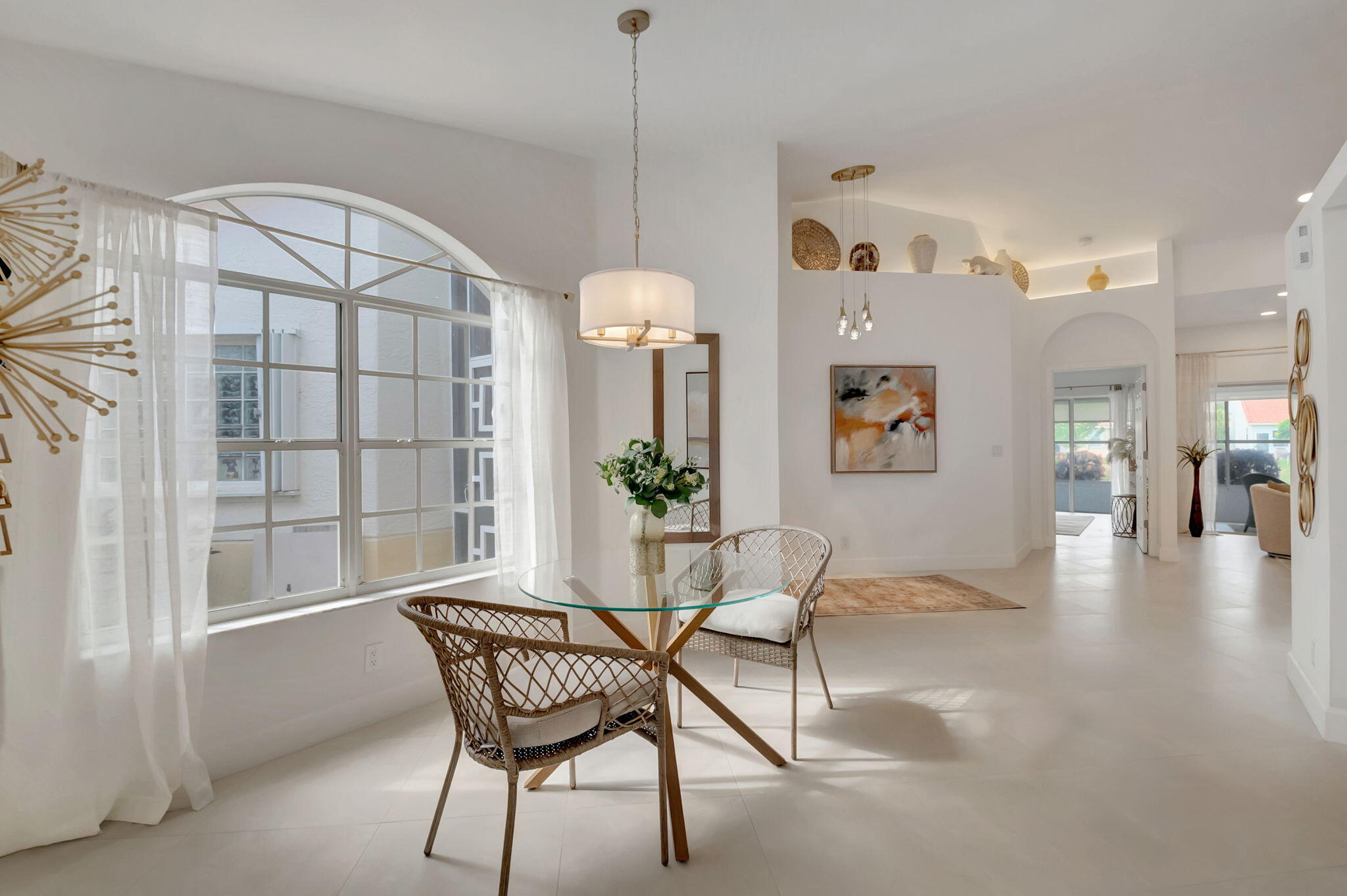 a view of a livingroom with furniture and a floor to ceiling window