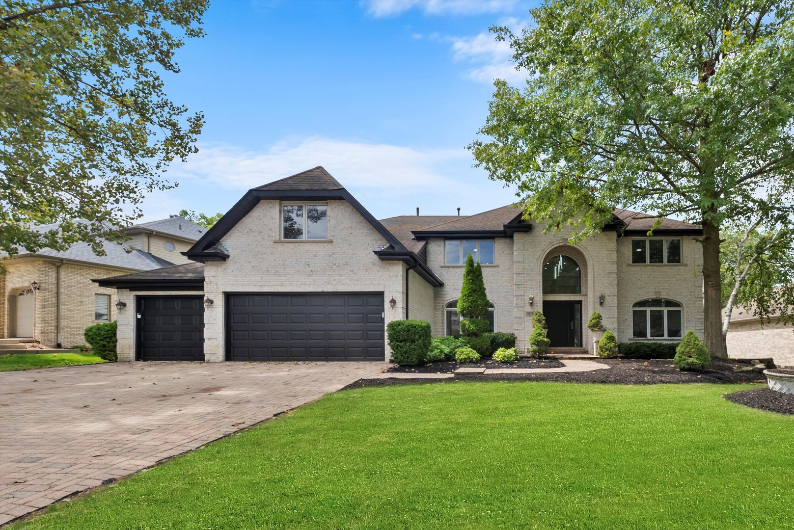 a front view of a house with a yard and garage