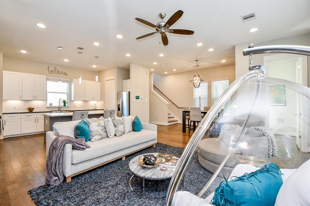 a living room with furniture and kitchen view