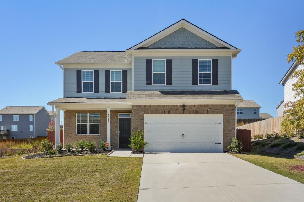 a front view of a house with a yard