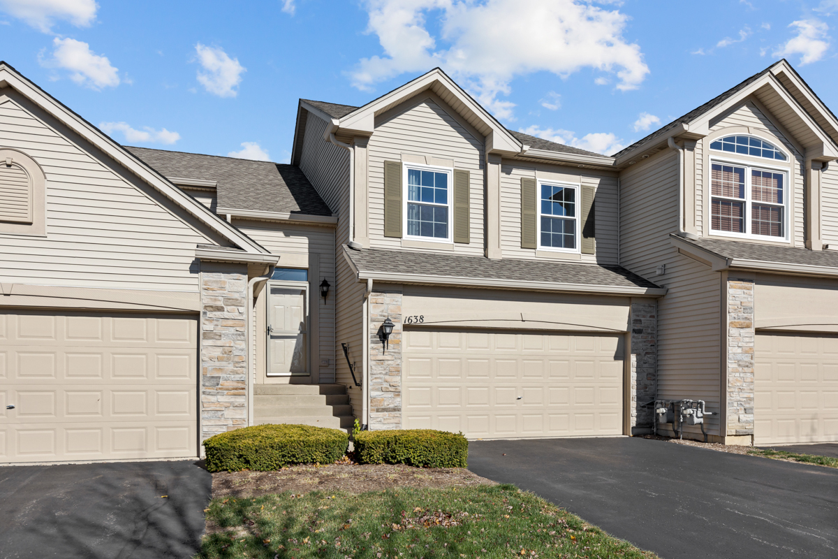 a front view of a house with a garage