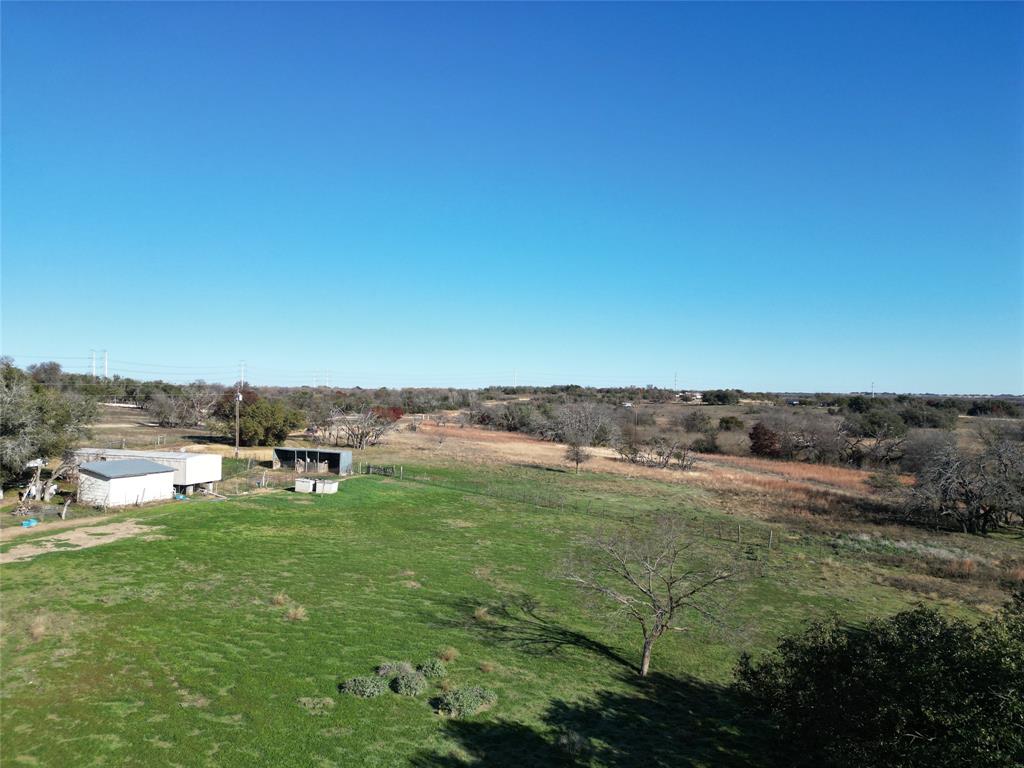 a view of a field with an ocean view