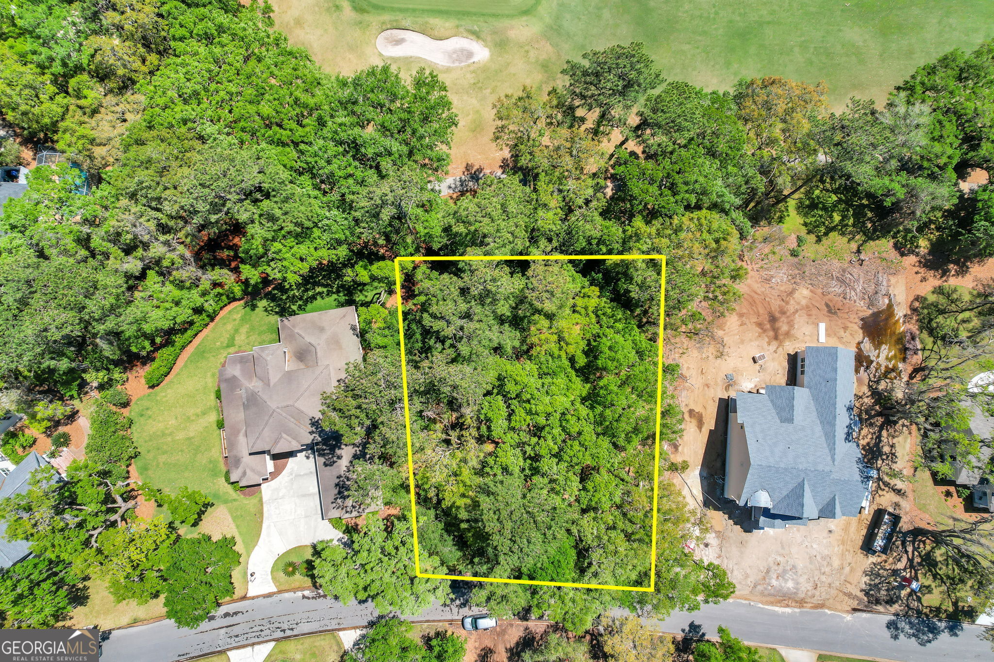 an aerial view of a house with a yard basket ball court and outdoor seating