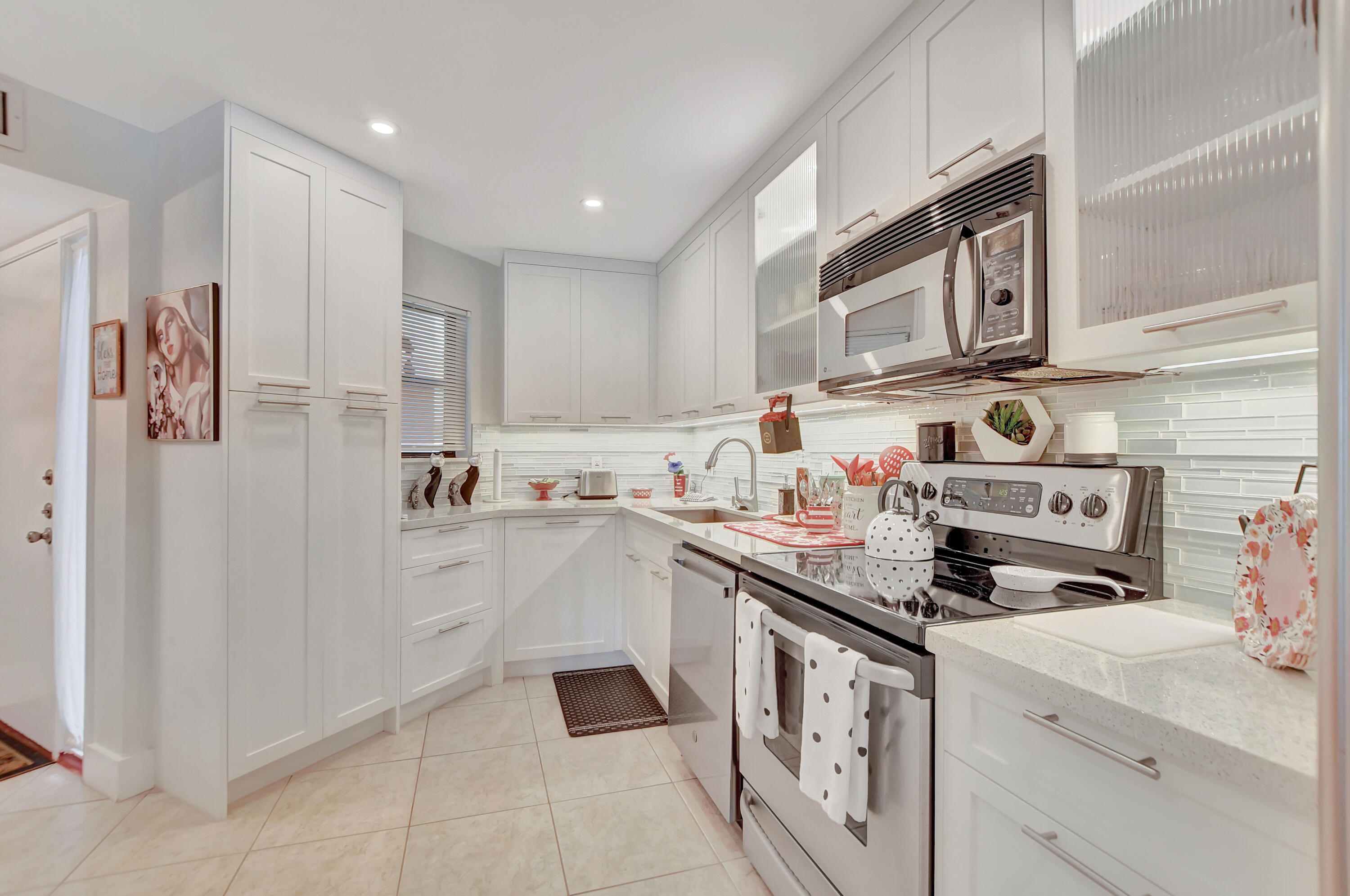 a kitchen with stainless steel appliances granite countertop a sink and cabinets