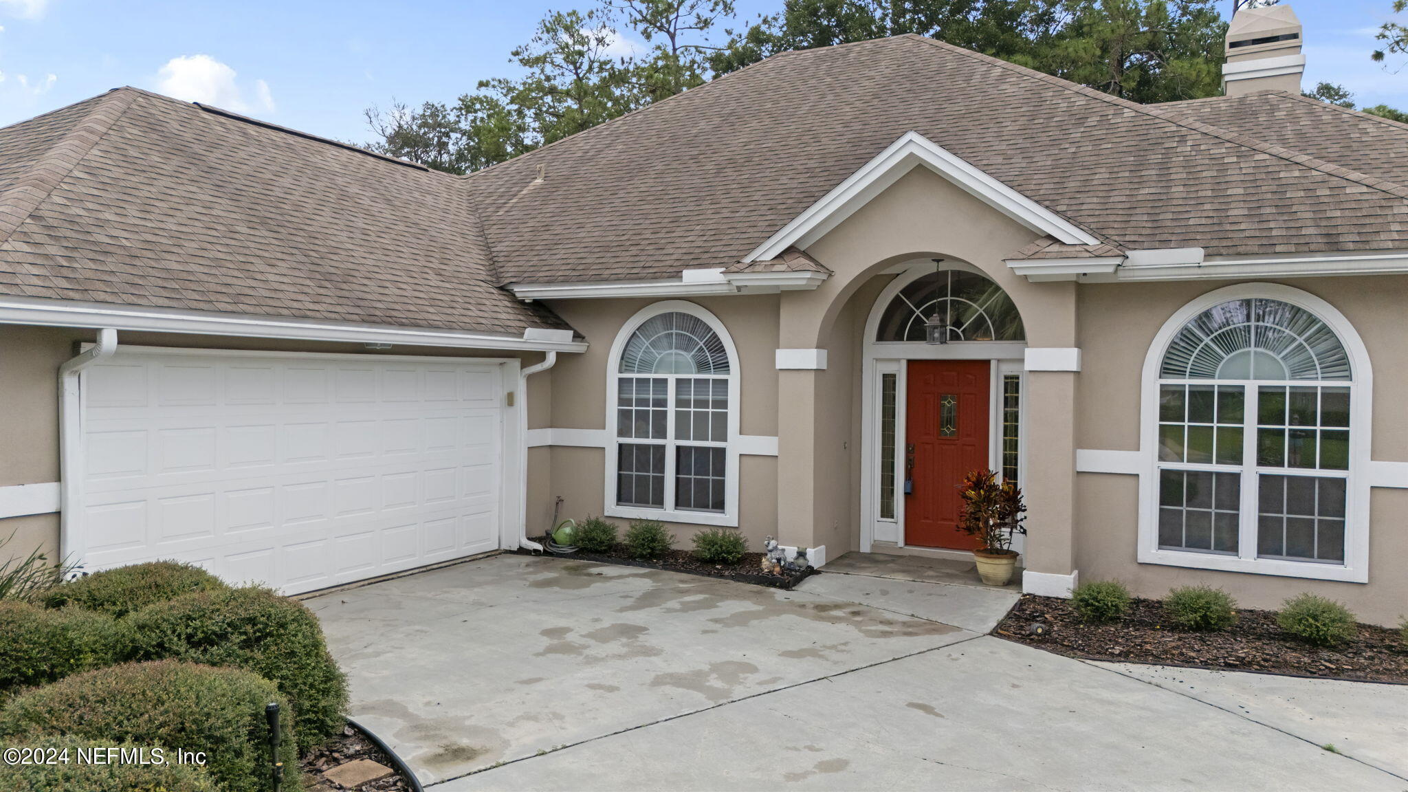 a front view of a house with garden