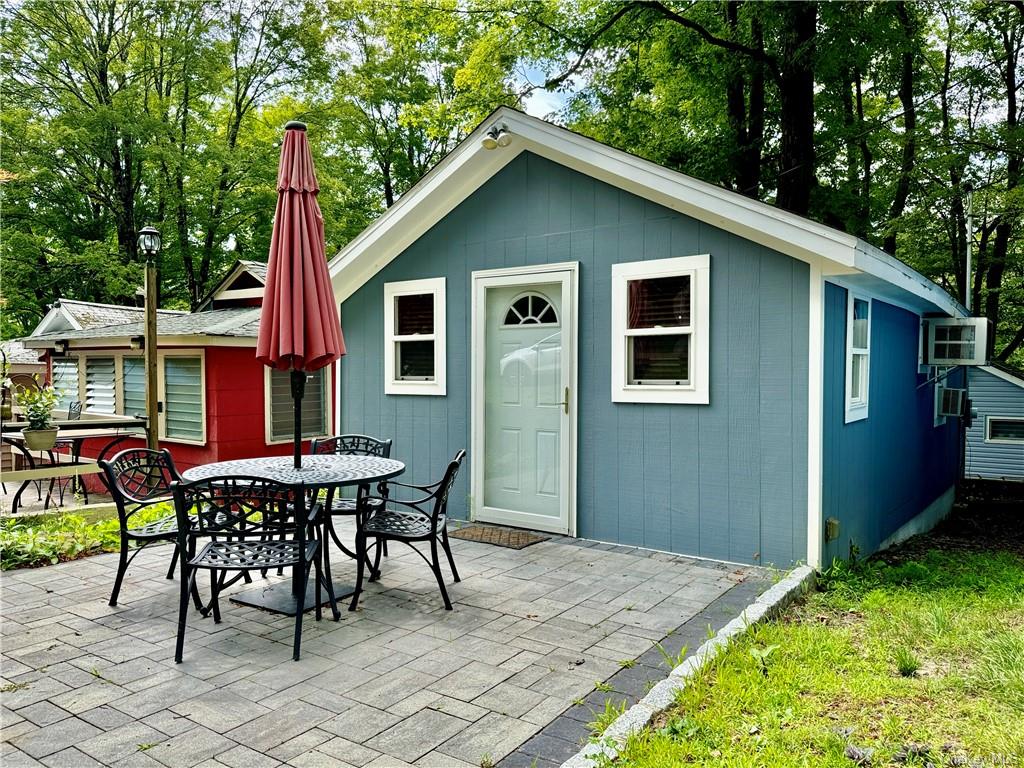 a backyard of a house with table and chairs