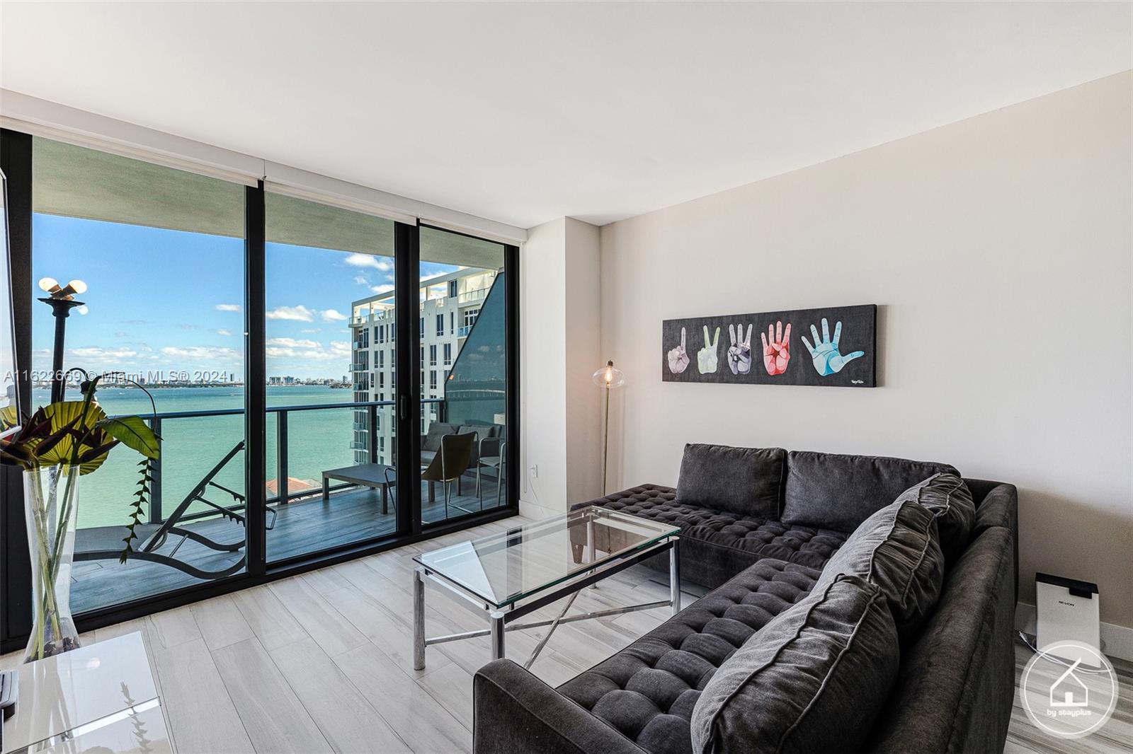 a living room with furniture and a floor to ceiling window