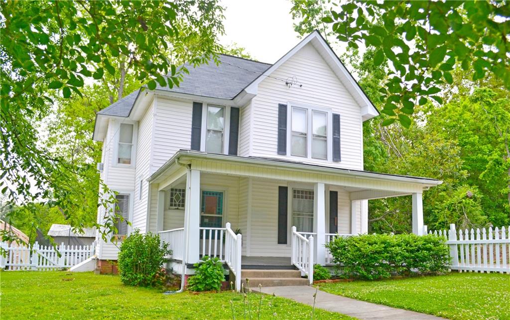 a front view of a house with a yard and porch