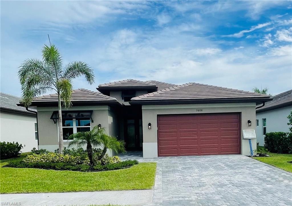 a front view of a house with a yard and garage