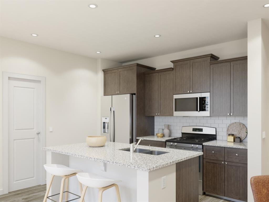 a kitchen with stainless steel appliances granite countertop a sink refrigerator and cabinets