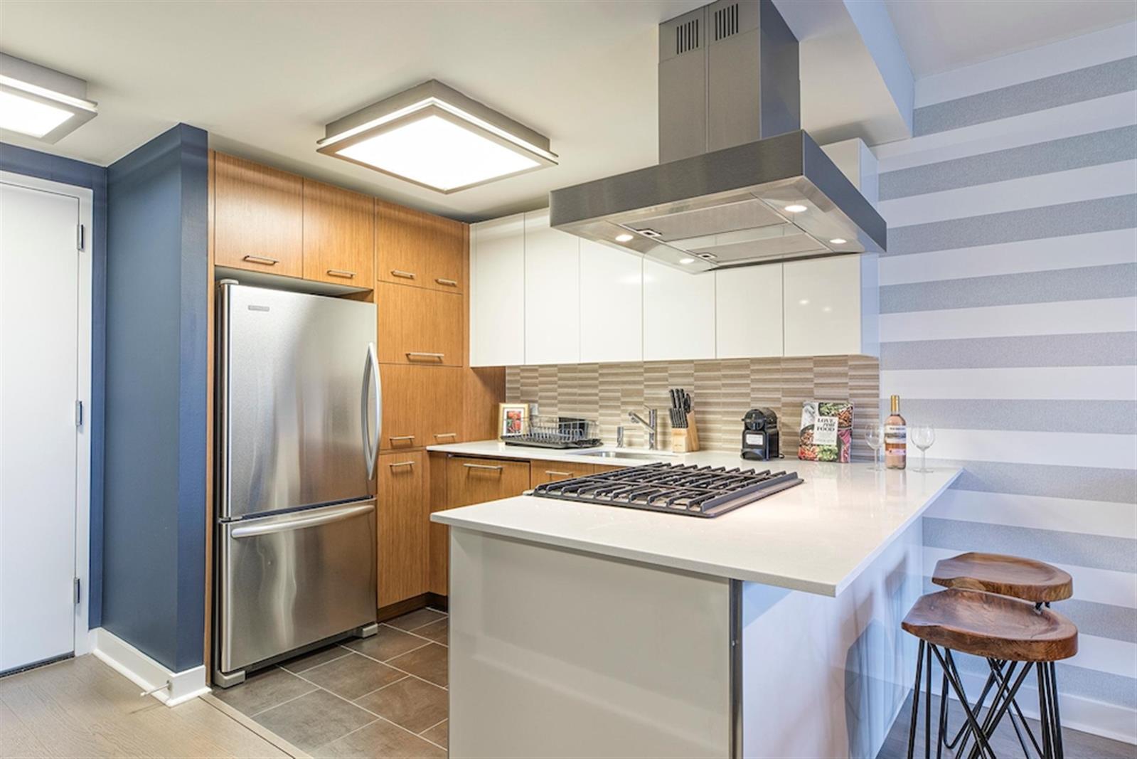 a kitchen with a refrigerator and a stove top oven