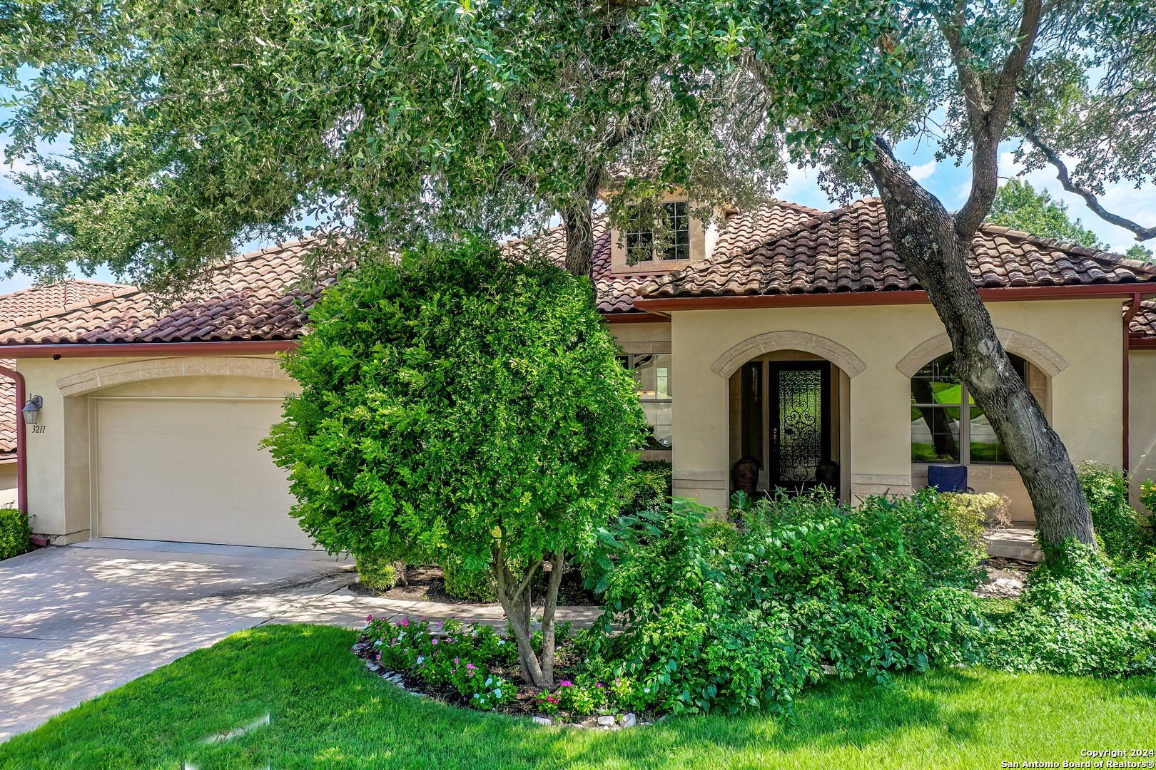 a front view of a house with garden