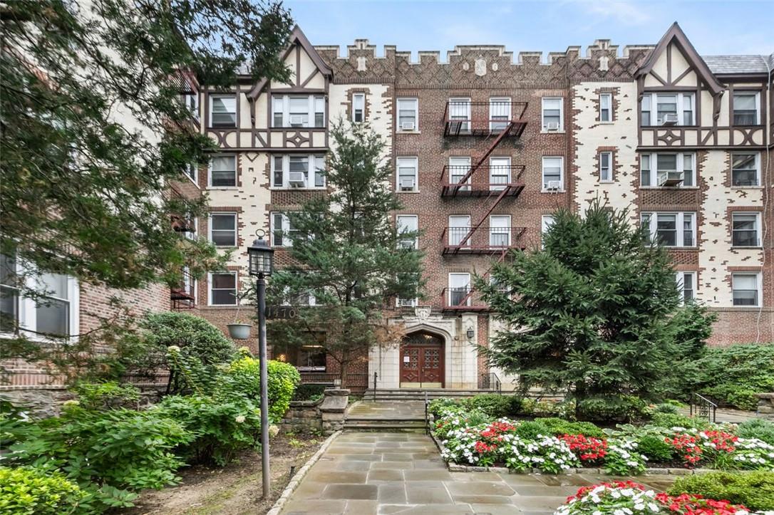 a front view of a residential apartment building with a yard