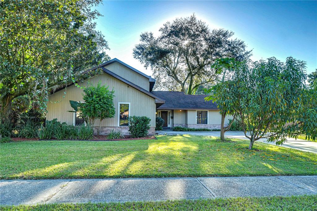 a view of a house with yard and tree s