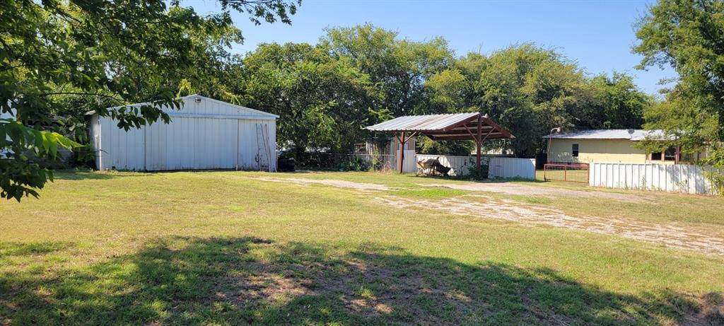 a view of a house with a yard and sitting area