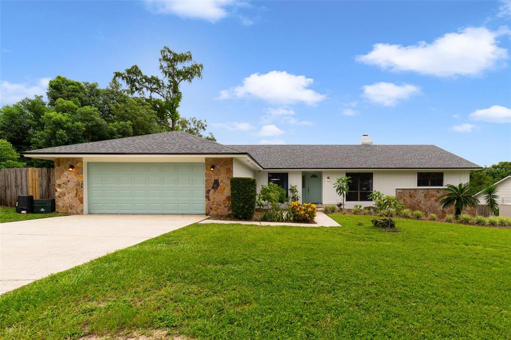 a front view of house with yard and green space