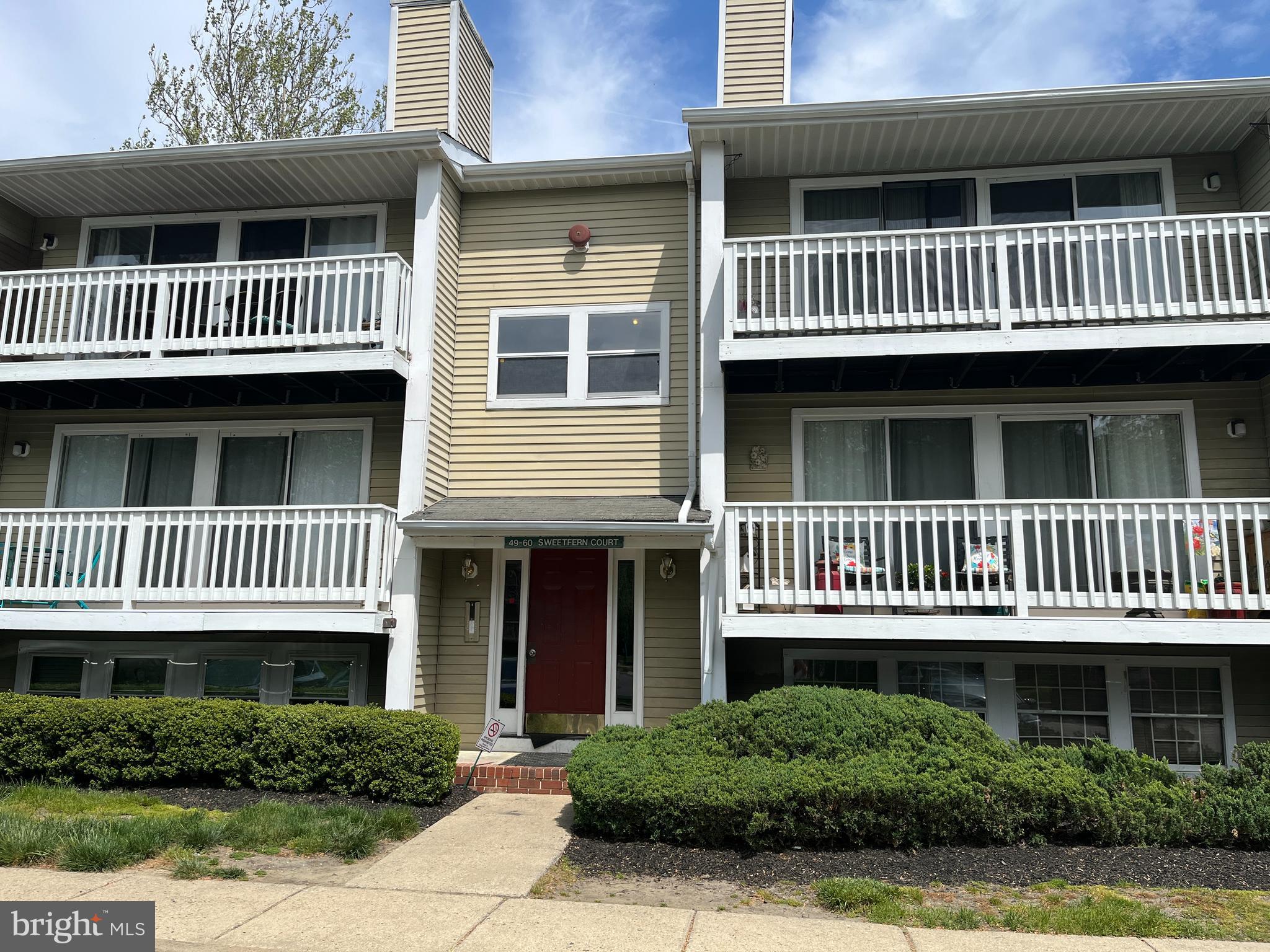 a view of a brick house with a deck