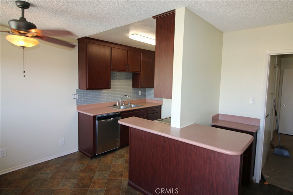 a kitchen with stainless steel appliances a stove a sink and a refrigerator