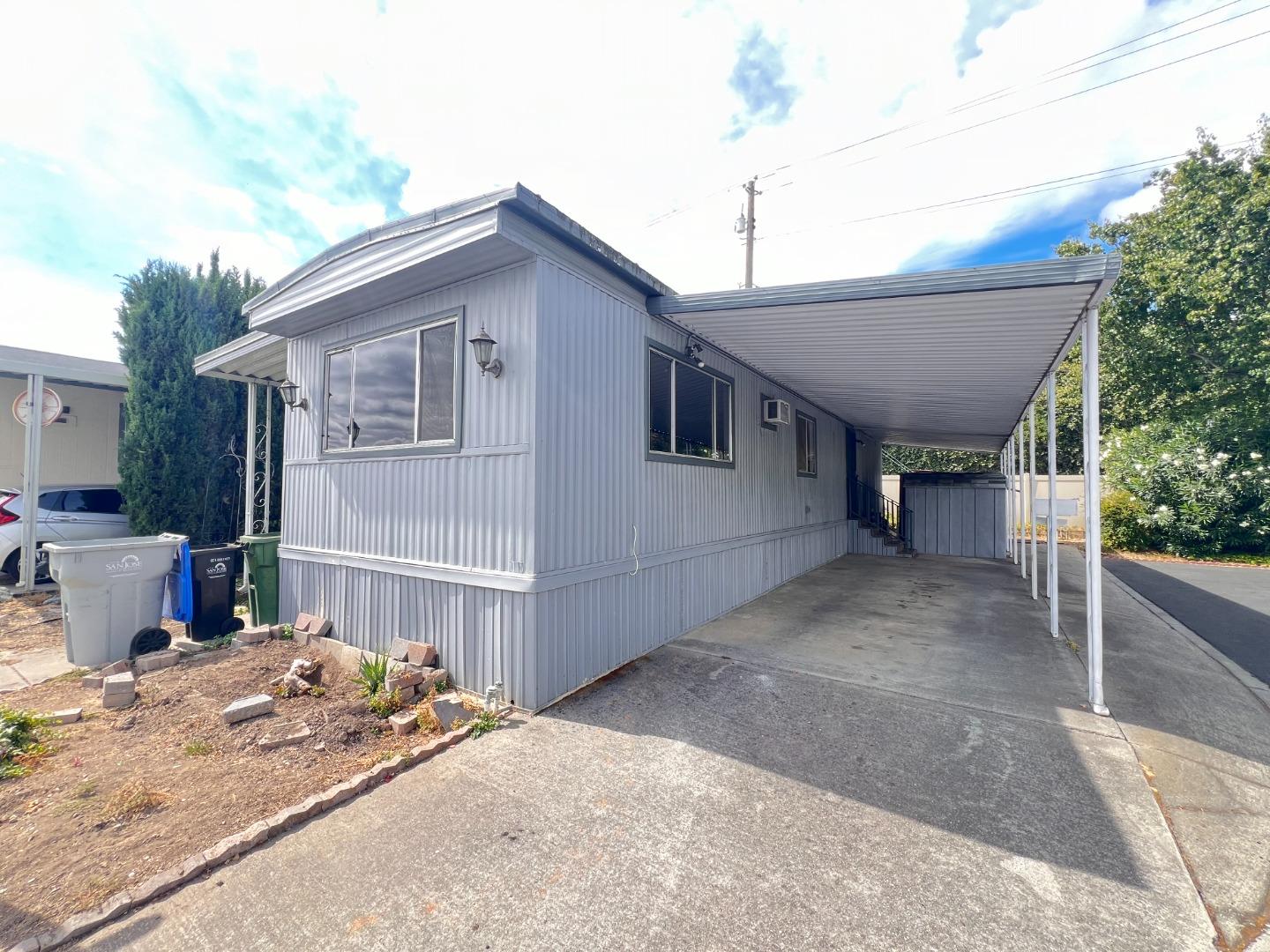 a view of a house with a patio and a yard