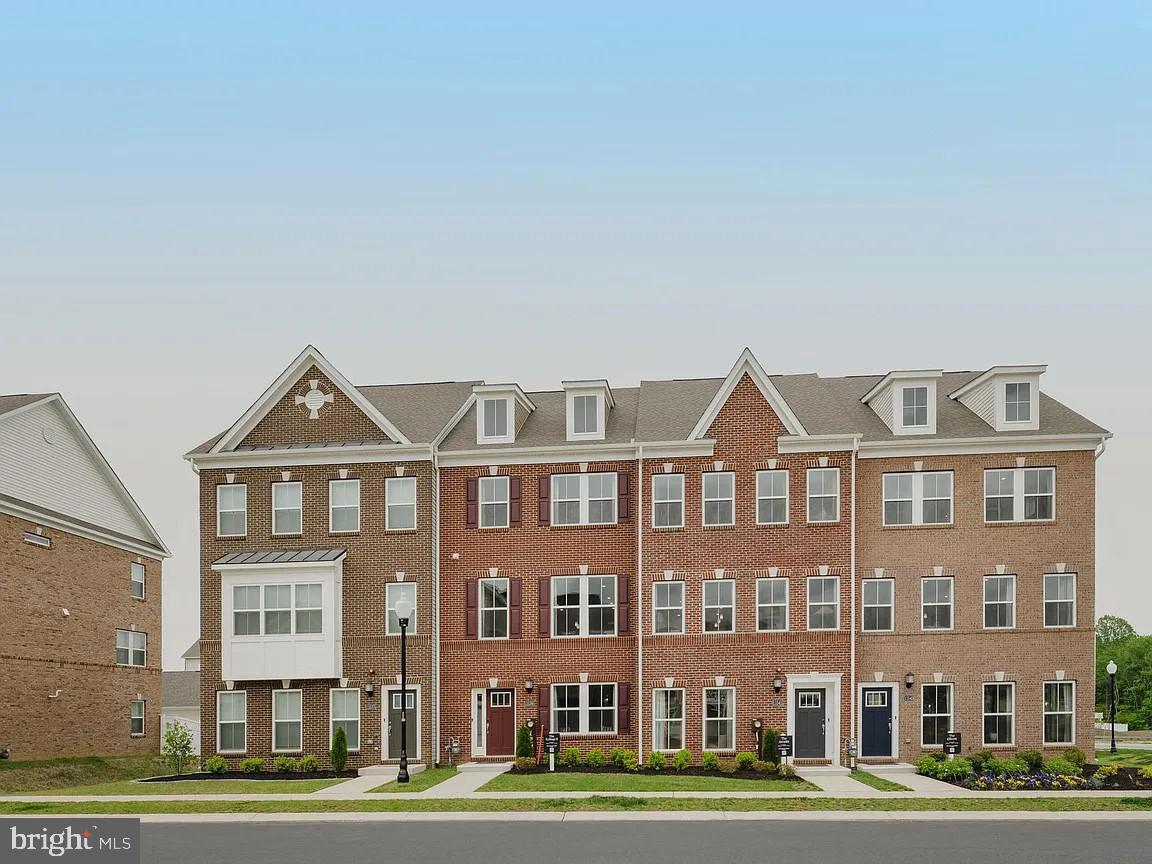 a front view of a residential apartment building with a yard