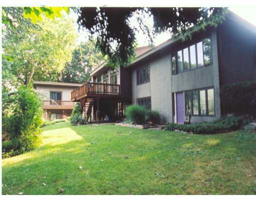 a backyard of a house with a garden and deck