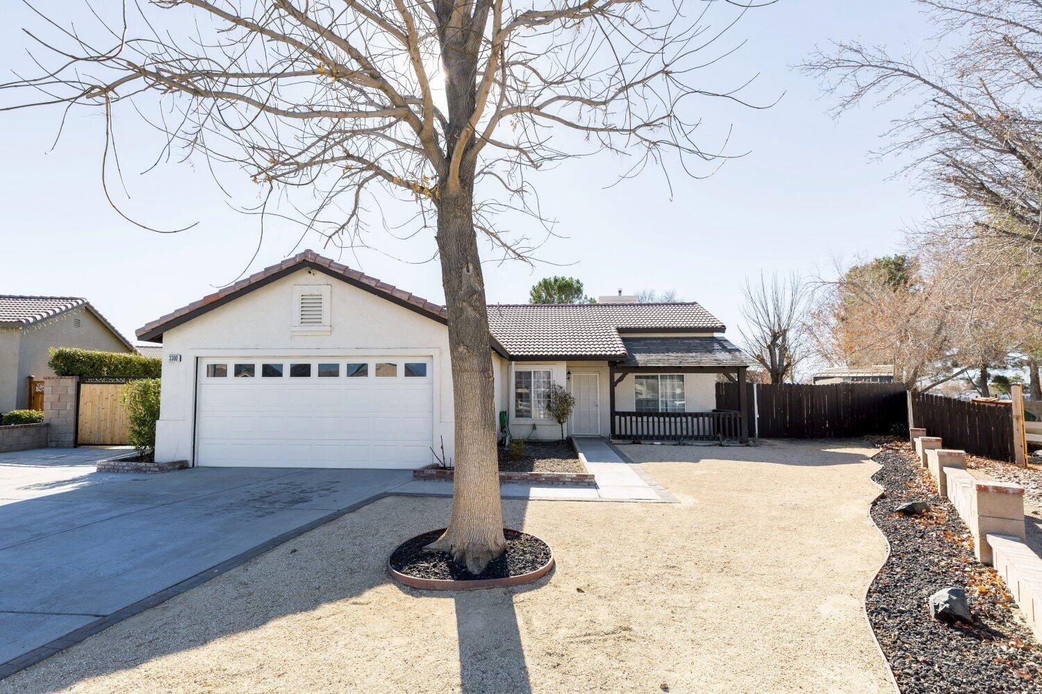 a view of a house with a yard covered with snow in the background