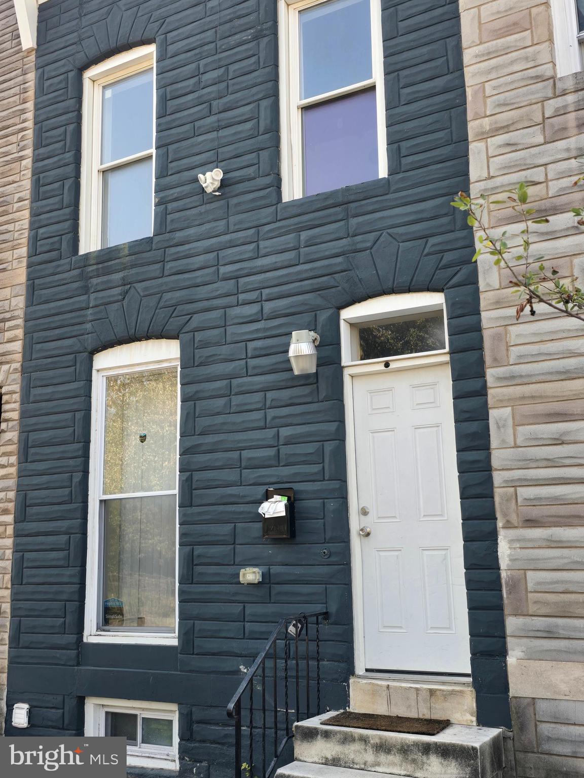 a view of a door and brick walls