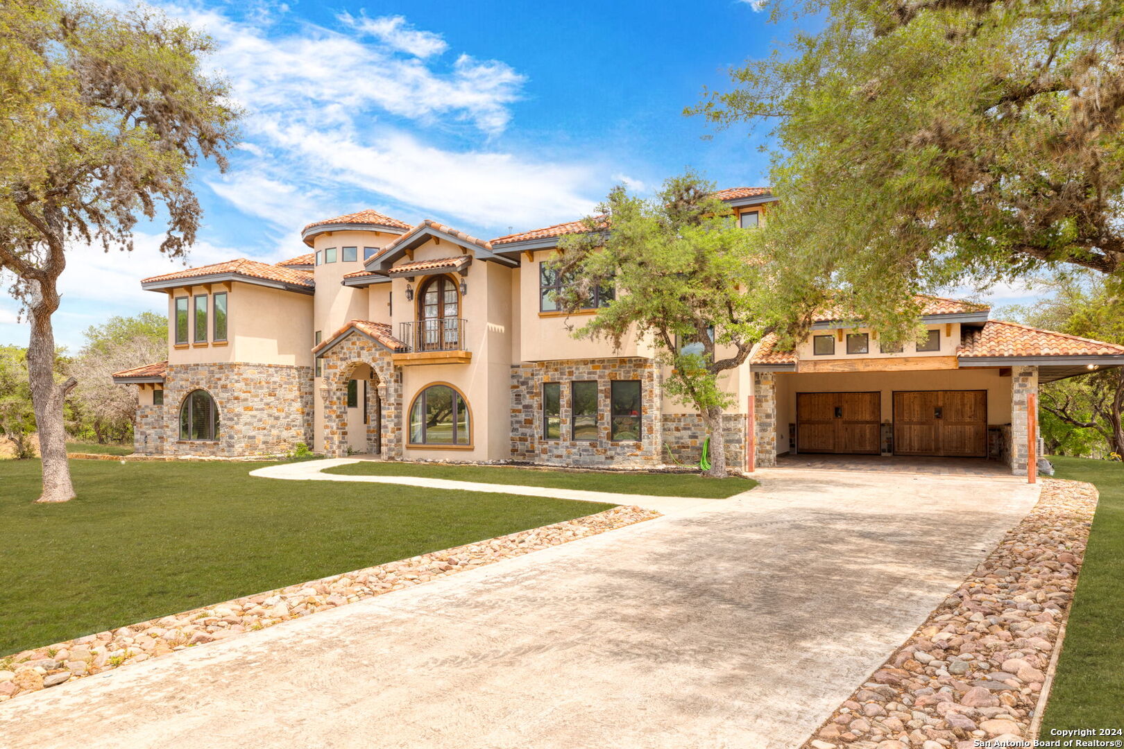 a big house with a big yard and large trees