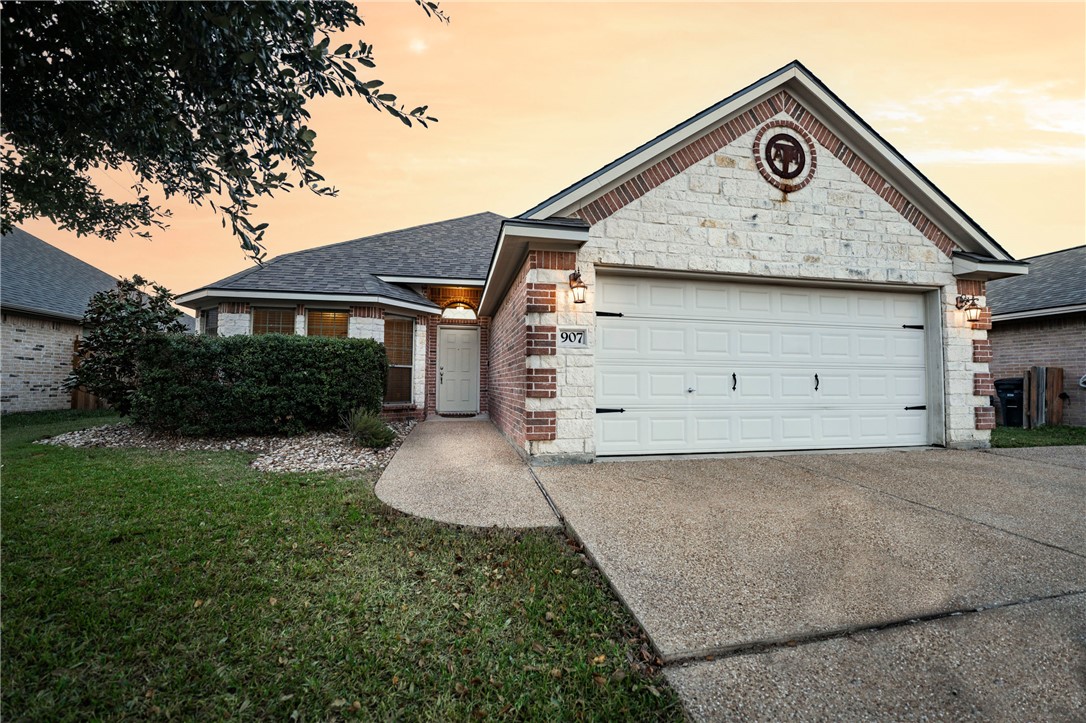 Ranch-style house with a garage and a yard