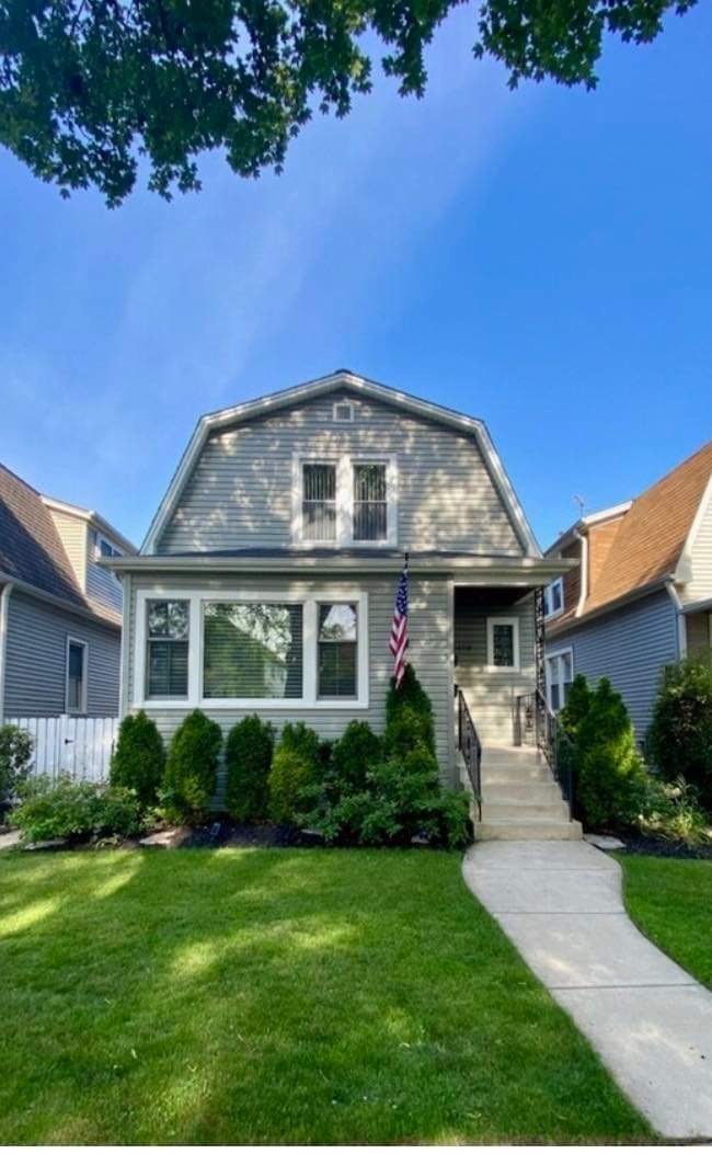 a front view of a house with garden