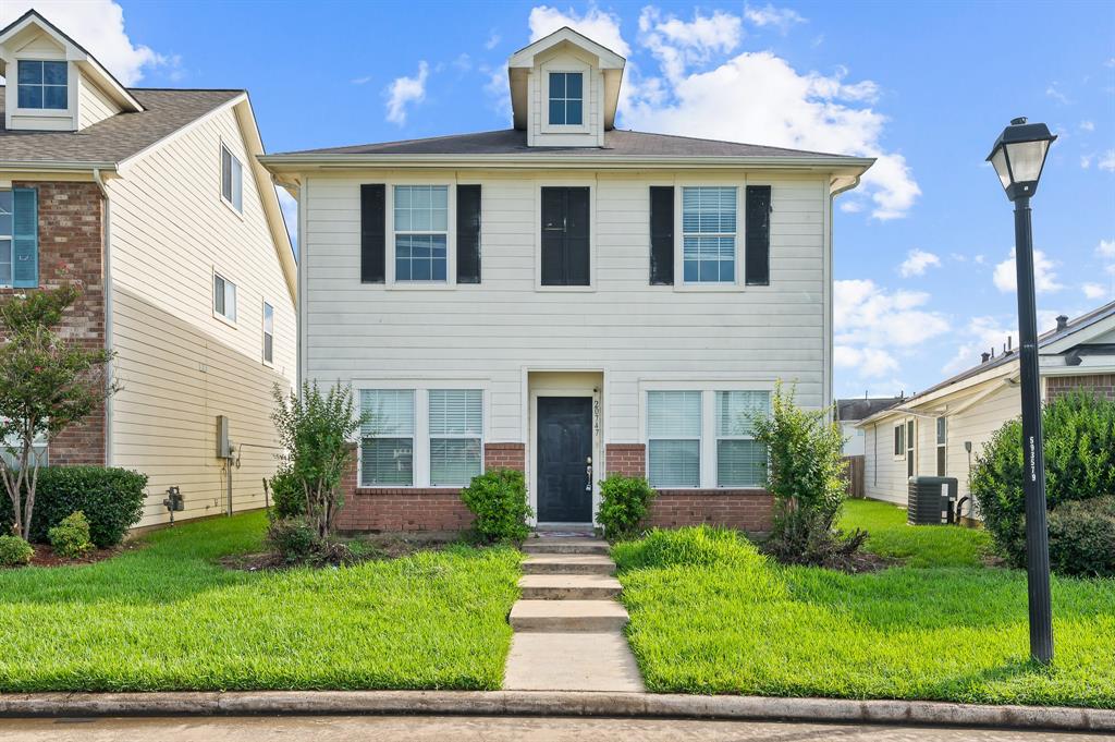 a front view of a house with a yard