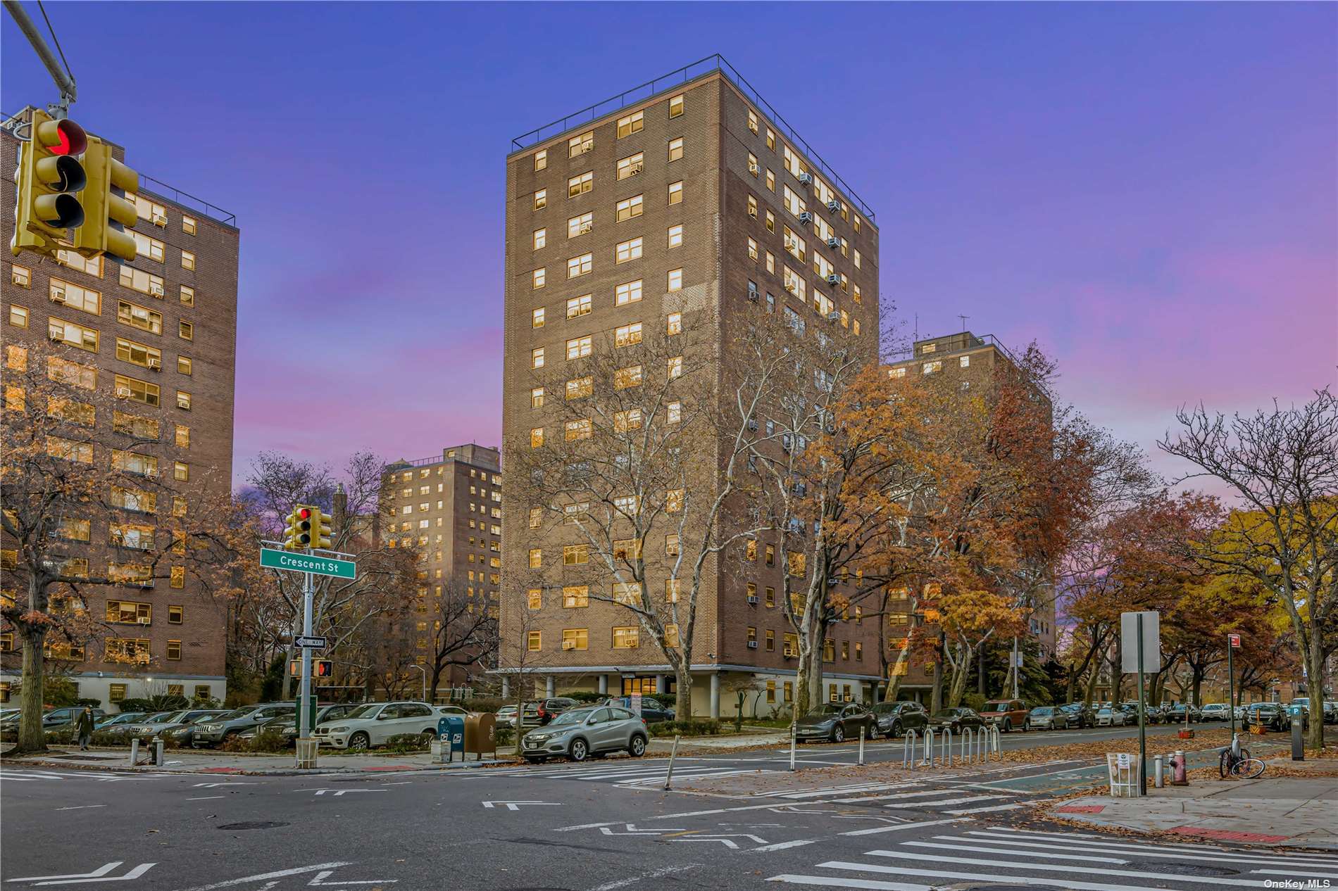 a view of a tall building next to a road