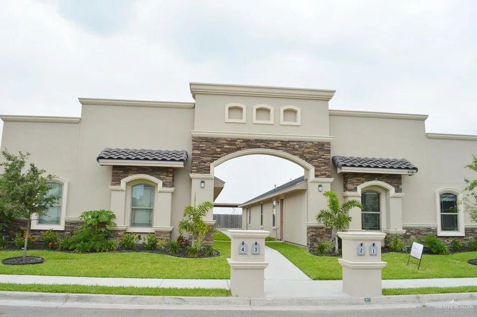 a front view of a house with a garden