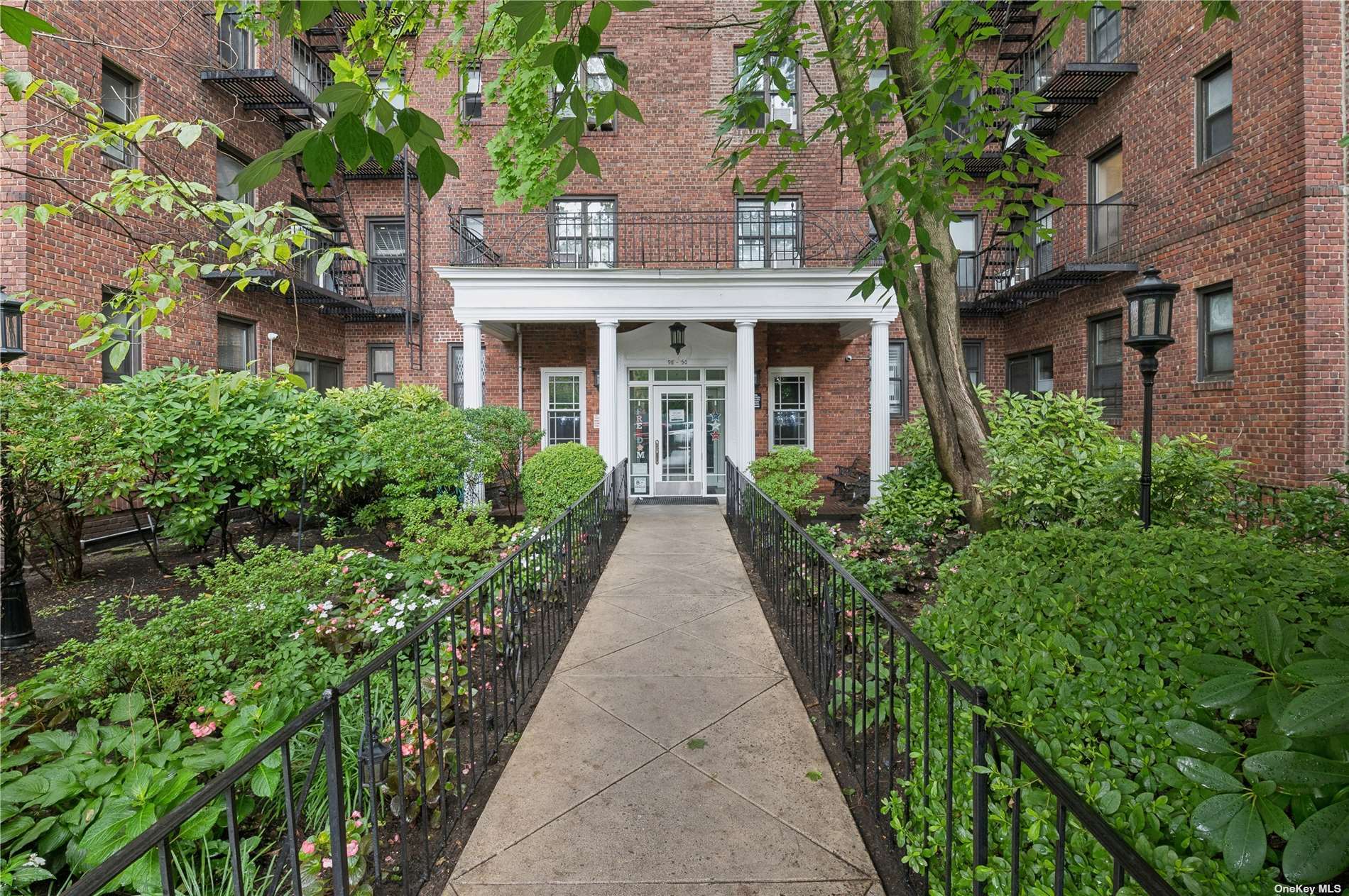 front view of a brick house with a yard