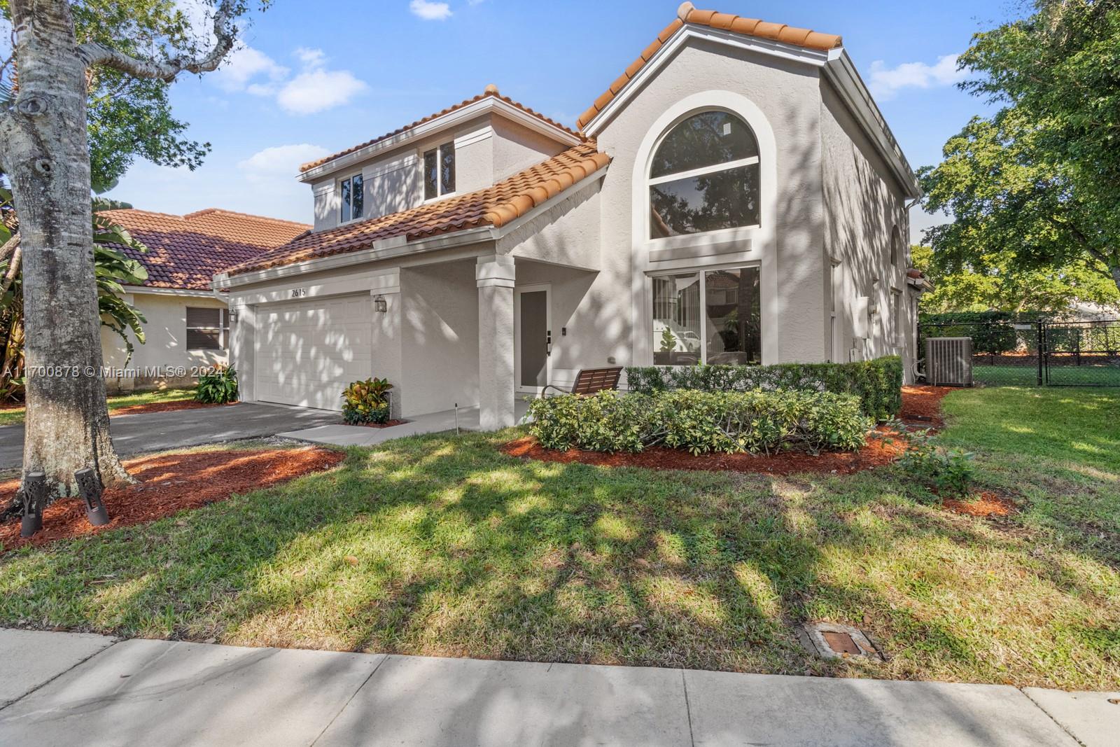 a front view of a house with a yard