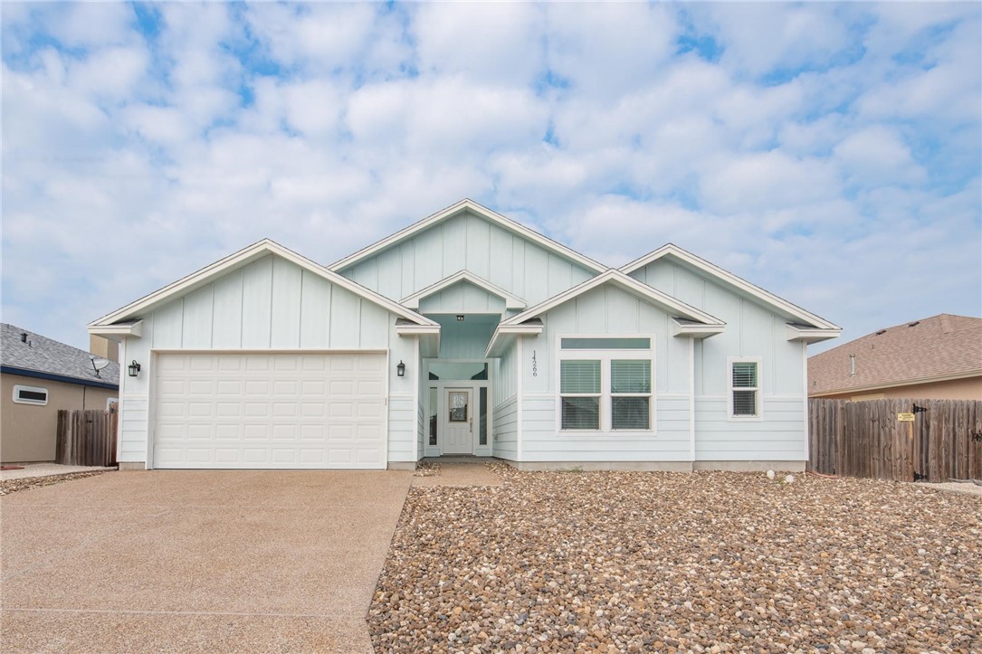 a view of a house with a yard and garage