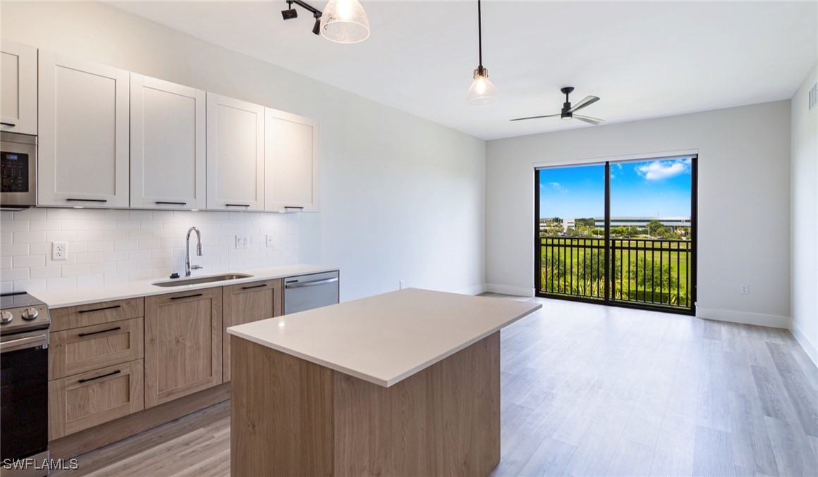 a kitchen with a sink a stove and cabinets