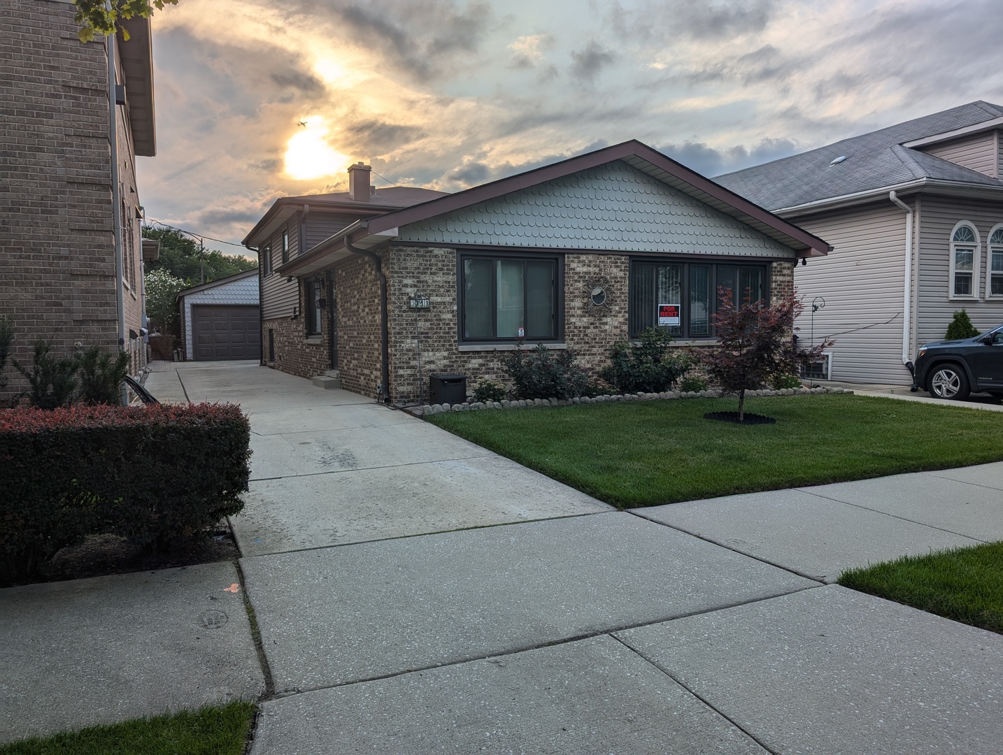 a front view of a house with a garden